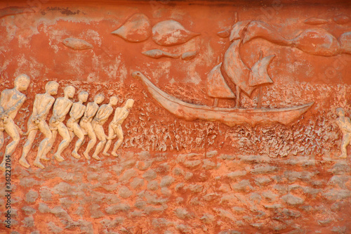 Chained slaves going to ship, relief on Door of No Return memorial, Ouidah, Benin photo
