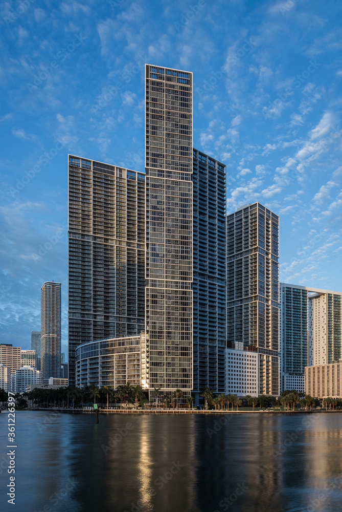 Miami, FL/USA - 06/20/2020: Icon Brickell luxury apartments towers lit by golden morning light. 