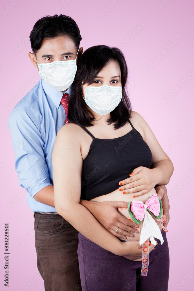 Young parents wears mask while holding headband