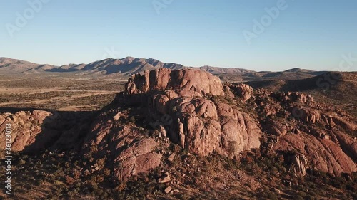 4K aerial drone video of African savanna hills, large red granite boulders range near B1 highway south of Windhoek in central highland Khomas Hochland of Namibia, southern Africa photo