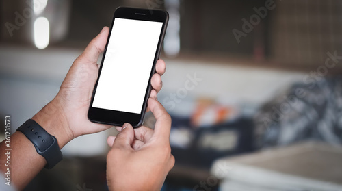Mock up smartphone of hand holding black mobile phone with blank white screen.