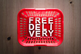 online purchases concept, shopping basket with Free Delivery text in it