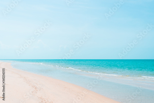 Tropical nature clean beach and white sand in summer with sun light blue sky and bokeh background. © ant