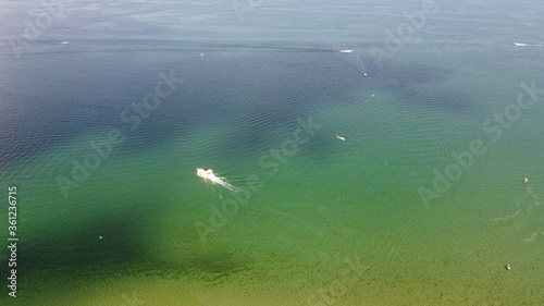 Aerial Image of a Boat Cruising Through Water © Ernest