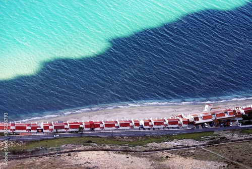 High angle shot of cabins with red roofs on the beach in Gibraltar