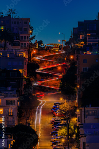 High angle view of illuminated homes on Lombard Street in San Francisco, California at sunset with car light trails