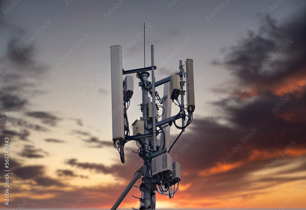 Telecommunication tower 4G and 5G. Macro Base Station or Base Transceiver Station. Wireless Communication Antenna Transmitter. Development of communication systems in urban area at sunset. Telecommunication tower 4G and 5G. Macro Base Station or Base Transceiver Station. Wireless Communication Antenna Transmitter. Development of communication systems in urban area at sunset.