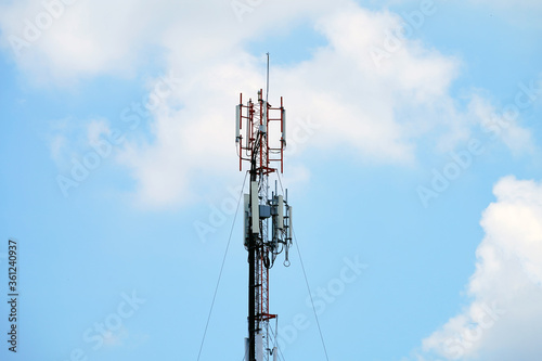 Telecommunication tower of 4G and 5G cellular. Macro Base Station. Wireless Communication Antenna Transmitter. Telecommunication tower with antennas against blue sky background.