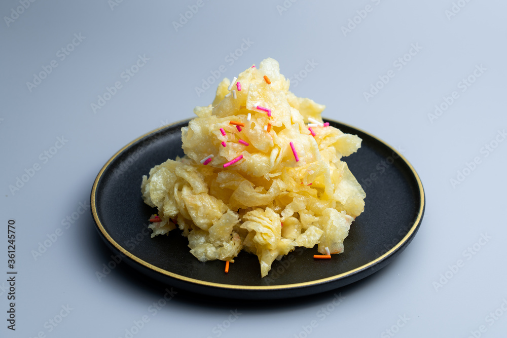 Chinese traditional Beijing snack with pastry fried with ginger juice and sugar. Old Beijing ginger sauce fork. Old Beijing snack fork. Chinese traditional Beijing snack with pastry fried with ginger juice and sugar. Old Beijing ginger sauce fork. Old Beijing snack fork.