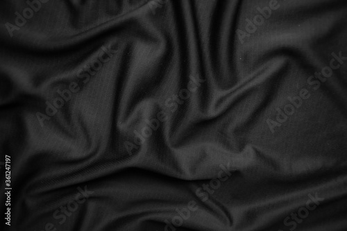 Background texture black cloth. Abstract dark wavy soft. Fabric is wrinkled. Fashion luxury style.