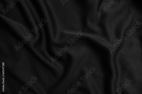 Background texture black cloth. Abstract dark wavy soft. Fabric is wrinkled. Fashion luxury style.