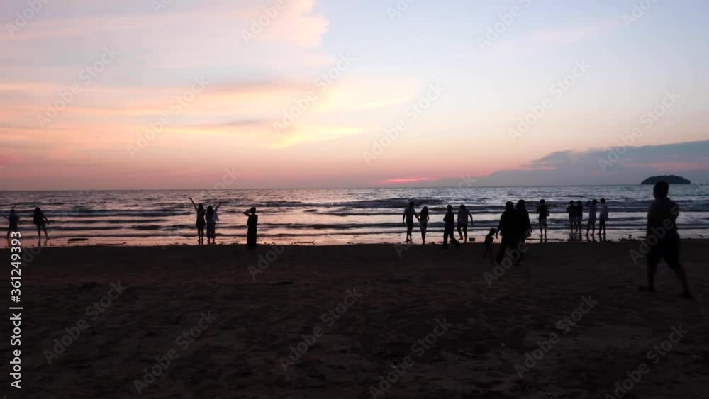 Time Lapse Shot Of Sunset in Kota Kinabalu At Tanjung Aru Beach, With People Watching and Taking Pictures Of The Sunset in Kota Kinabalu, Malaysian Borneo. Time Lapse Shot Of Sunset in Kota Kinabalu At Tanjung Aru Beach, With People Watching and Taking Pictures Of The Sunset in Kota Kinabalu, Malaysian Borneo.