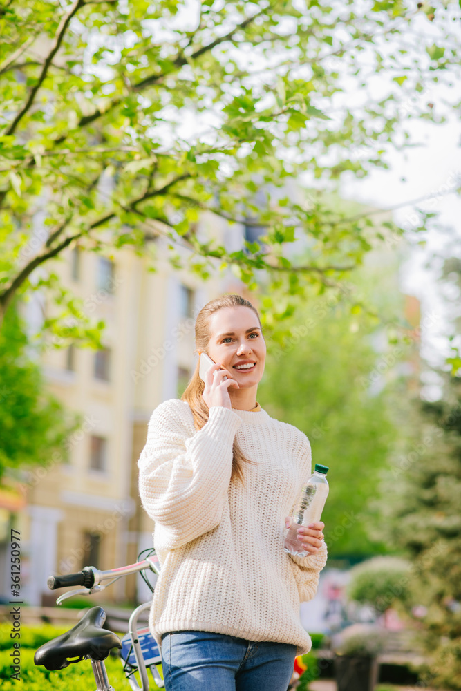 Pretty woman talking on smartphone in green square. Pretty woman talking on smartphone in green square.
