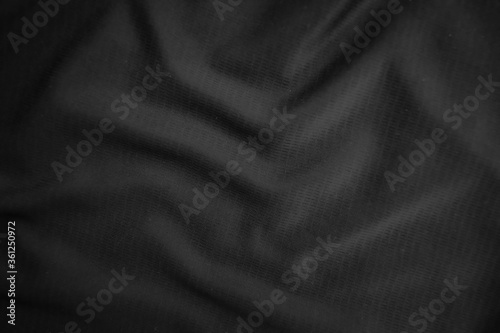 Background texture black cloth. Abstract dark wavy soft. Fabric is wrinkled. Fashion luxury style.