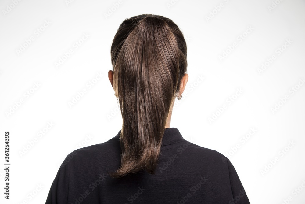 Back view of a female dark brown straight hair ponytail small earrings  black shirt white background Stock Photo | Adobe Stock
