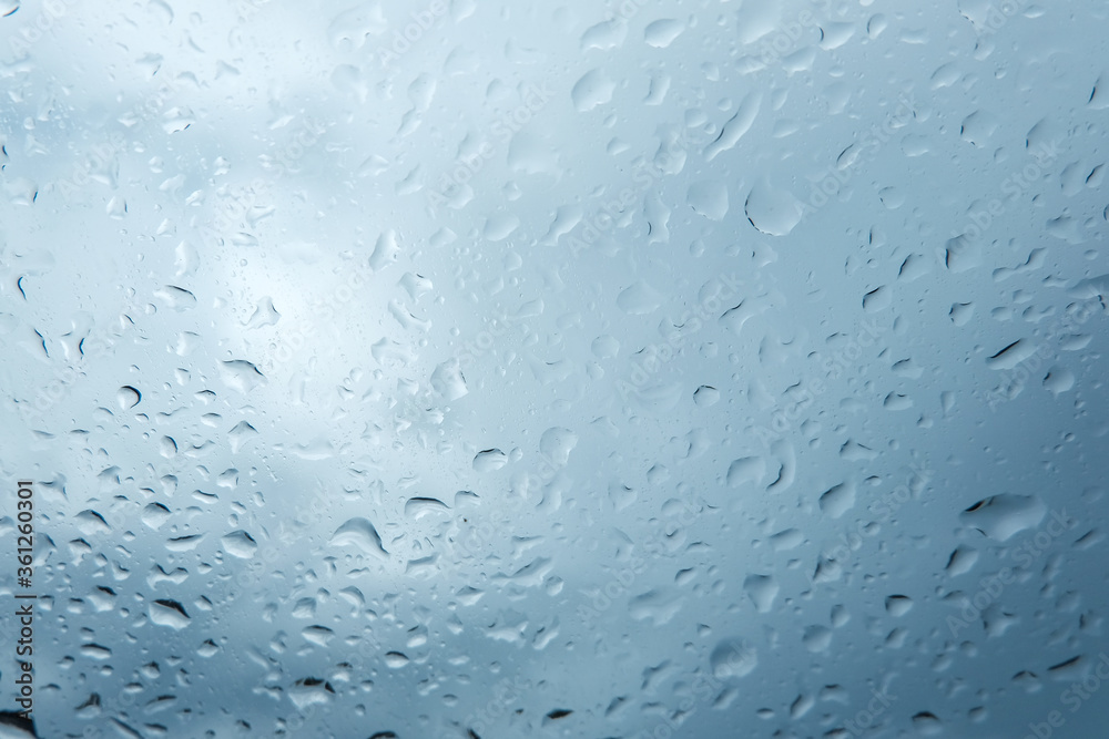 Rain drops on car window, Textures of water droplets of rain flow Rain drops on car window, Textures of water droplets of rain flow