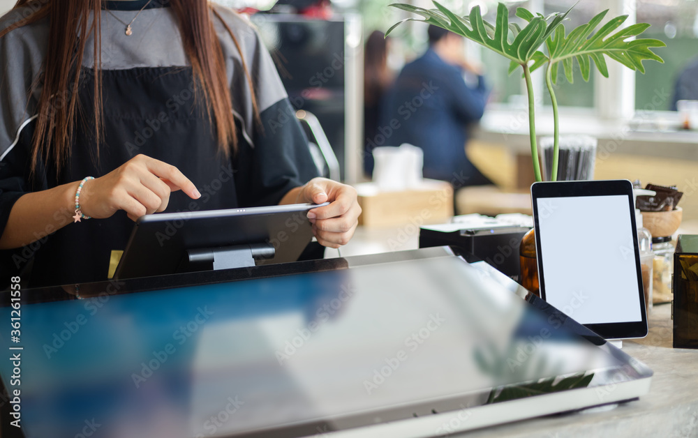 Fototapeta premium Young asian woman use digital tablet to receive orders from customers