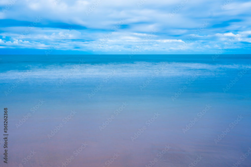 Sea landscape and sandy beach in the morning Fog against the background of a cloudy at sun rise time.Chanthaburi Coast, Thailand.soft focus.