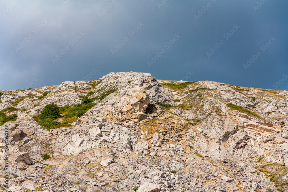 Top of the mountain close-up on a background of summer sky