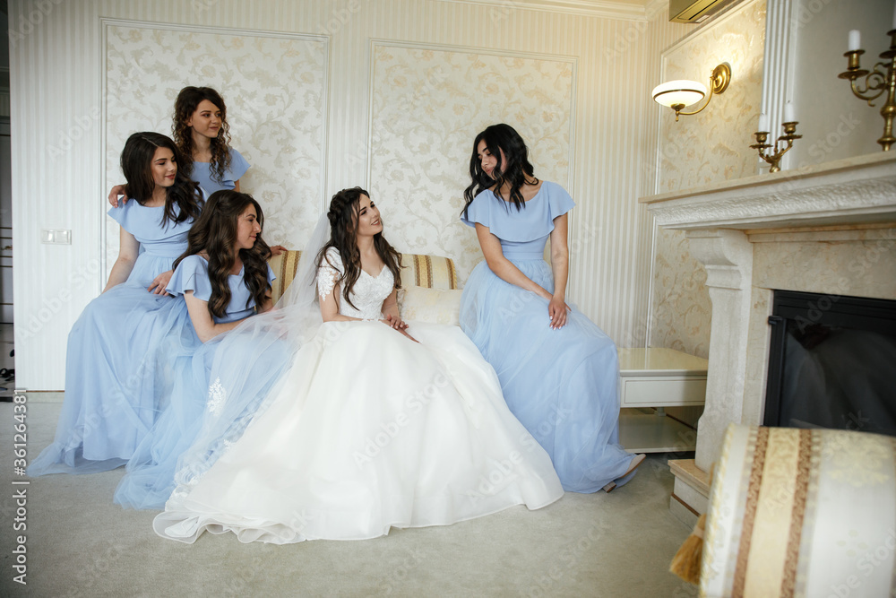 Cheerful bride & bridesmaids with bouquets posing outdoors closeup