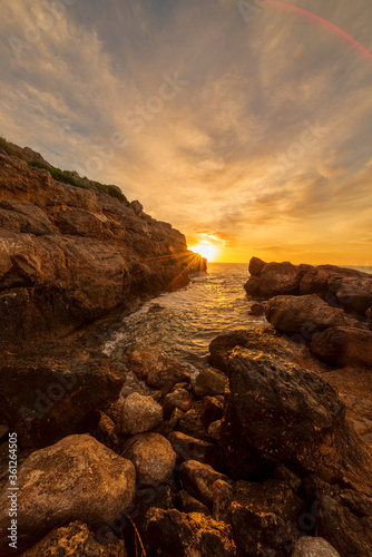 Sunrise between the rocks of the renega in Oropesa