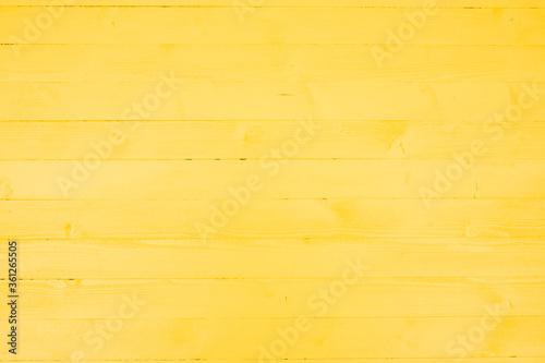 Yellow background made of small wooden boards photo