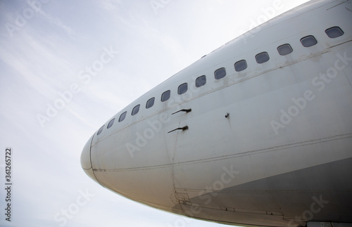 Close-up and high-view shot with beautiful blue sky background of airplane s head part which has been used for flight service for long time showing water stain and rust on the metal surface.