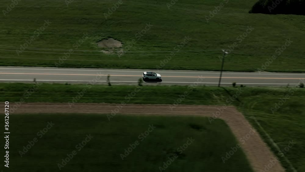 White Hyundai Car On A Road Trip In Quebec, Canada On A Bright Weather - aerial drone