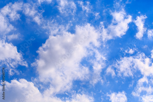 Bright cumulus clouds against the blue sky. Sunset sky Natural background.