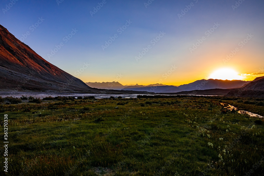 Beautiful sunset in the Pamir mountains, on the Zortashkol river, Tajikistan.