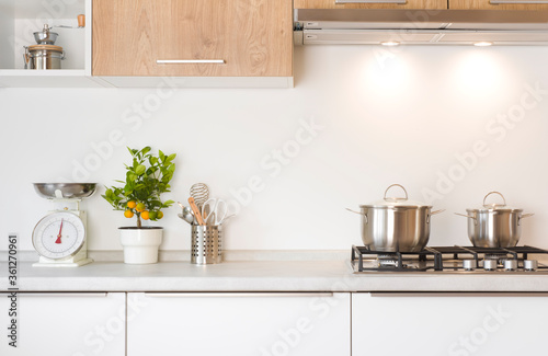 Working zone of modern kitchen with gas stove and utensils