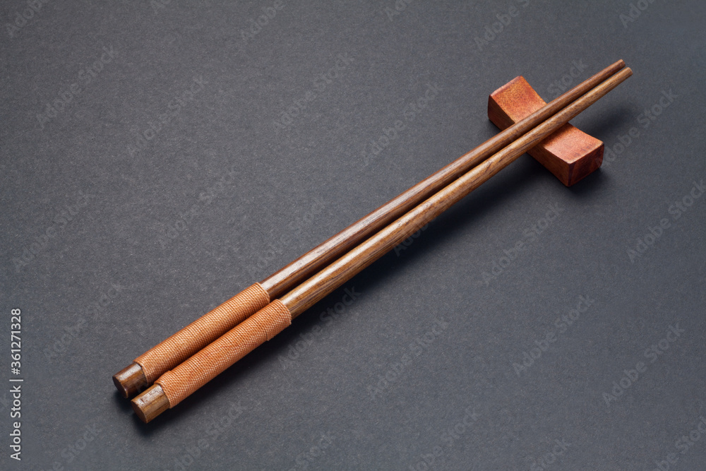 Wooden chopsticks on black paper background Wooden chopsticks on black paper background