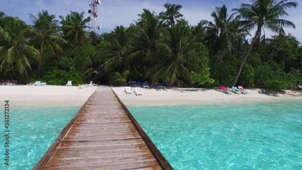 Maldive island. Walking on wooden bridge. Maldives travel destination. Blue lagoon. Cottage in Indian ocean. Relaxation and romantic place. White sand beach. Maldive island. Walking on wooden bridge. Maldives travel destination. Blue lagoon. Cottage in Indian ocean. Relaxation and romantic place. White sand beach.