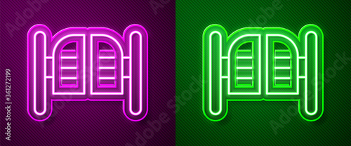 Glowing neon line Old western swinging saloon door icon isolated on purple and green background. Vector Illustration.