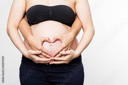 pregnant woman holding her belly with hands