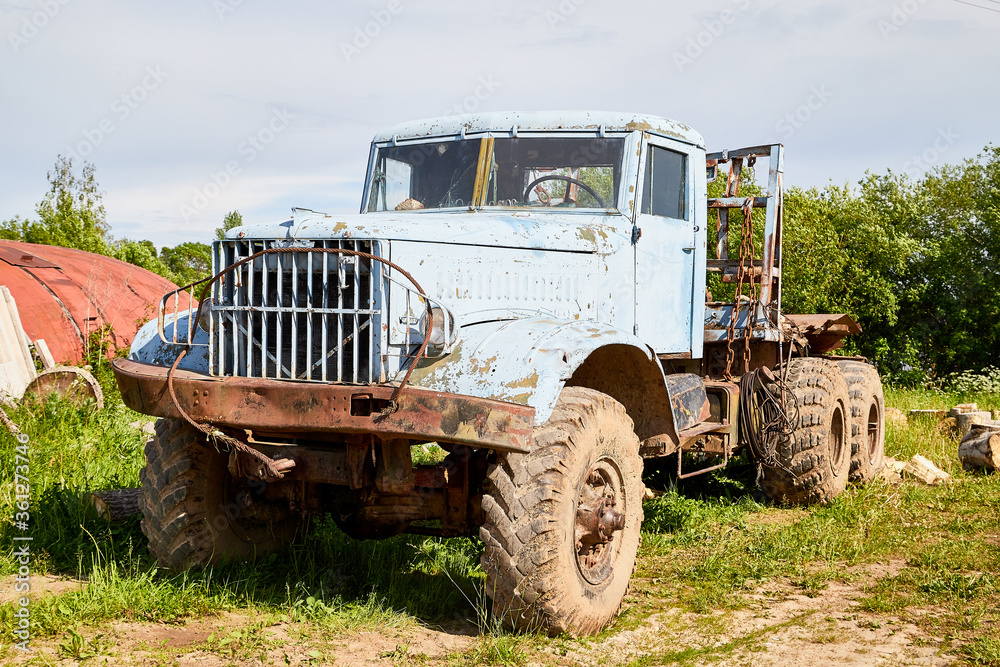 Dirty truck on a country green grass in a sunny summer day with blue sky. Dirty truck on a country green grass in a sunny summer day with blue sky.