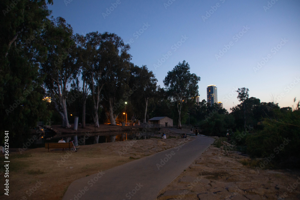 Ha-Yarkon park river and Ramat Gan business buildings on the background at evening, Tel Aviv, Israel.