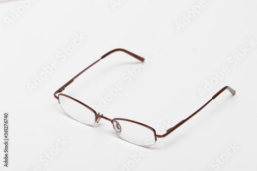 Spectacle frame with fishing line on a white background