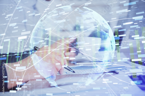 Double exposure of hands and notepad with business icons.