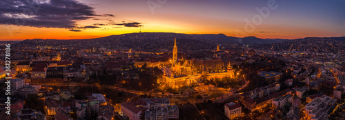 Aerial panorama drone shot of lighted Matthias Churh Fisherman's Bastion on Buda Hill in Budapest sunset time