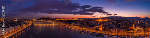 Panoramic aerial drone shot of lighted quai of Buda Hill by Danube in beautiful Budapest sunset