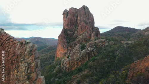 Dramatic rock formation reveal, Warrumbungles in Australia, aerial pull-back photo