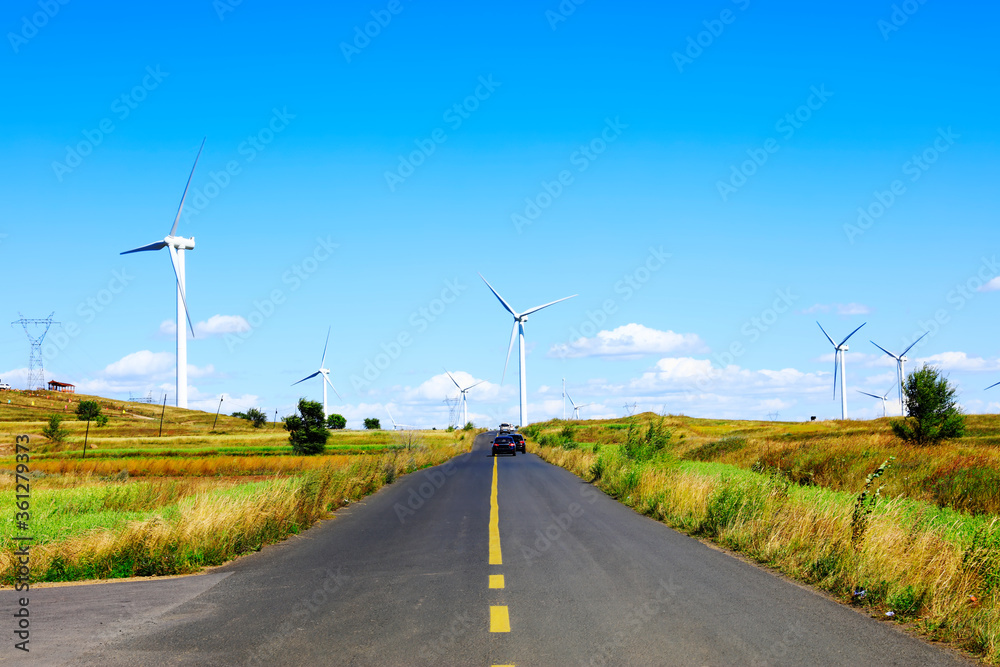 Asphalt road and wind turbines