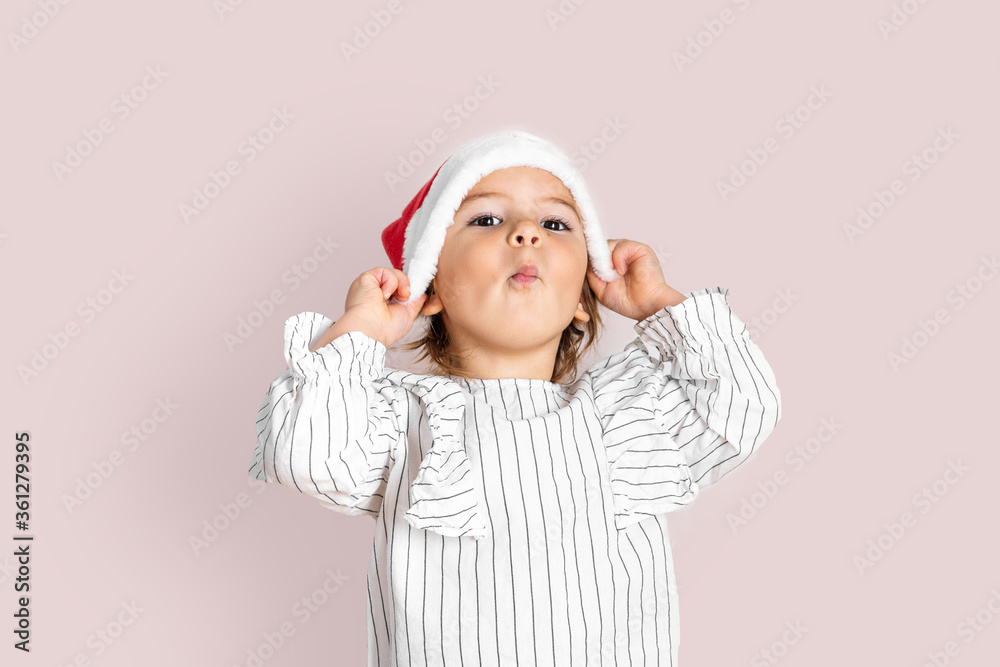 Portrait of toddler girl in red hat on Christmas. Surprise concept Portrait of toddler girl in red hat on Christmas. Surprise concept