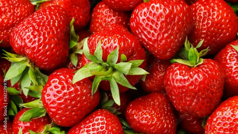 Beautiful ripe red strawberries close-up top view, turning.
