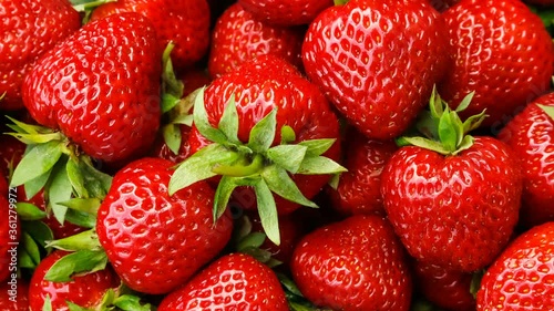 Beautiful ripe red strawberries close-up top view, turning.