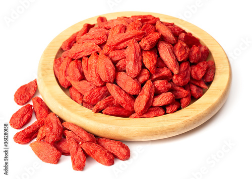 Dried Chinese wolfberries in the wooden bowl, isolated on white