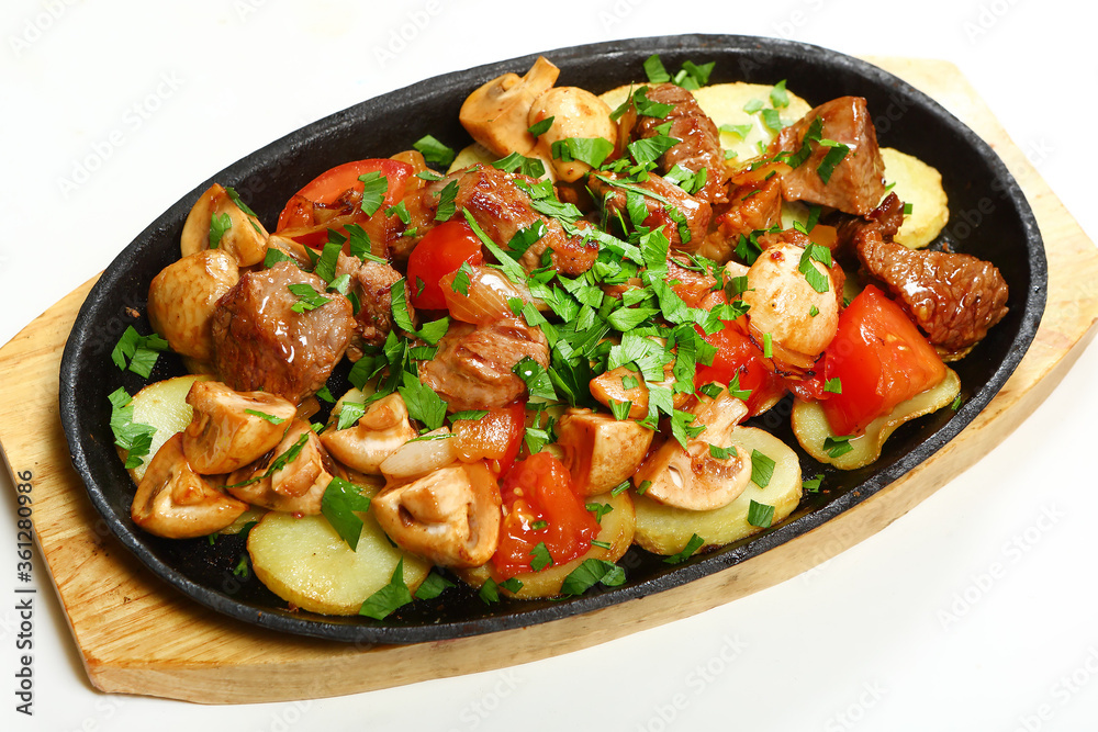 Sizzling skillet. Fried pork with vegetables. Sizzling skillet. Fried pork with vegetables.