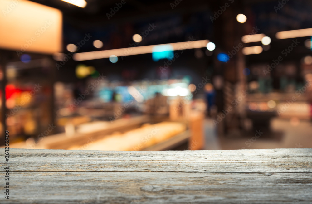 Empty wood table top on blurred market fruit. can montage or display your products