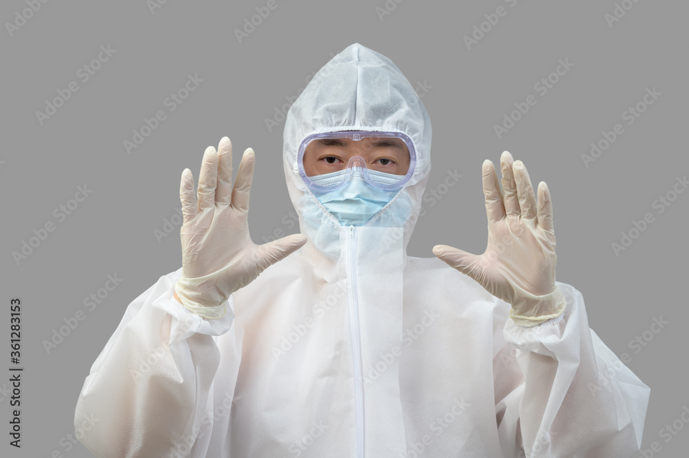 An Asian man wearing protective suit, medical masks, and goggles on a gray background.
